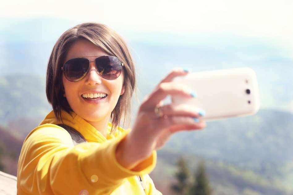 Tourist taking selfie in the mountains